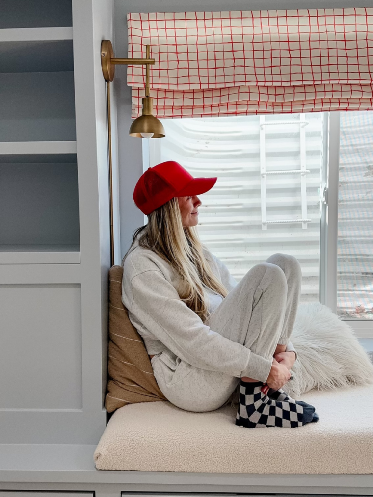 DIY Bench Cushion with Sarah sitting on bench